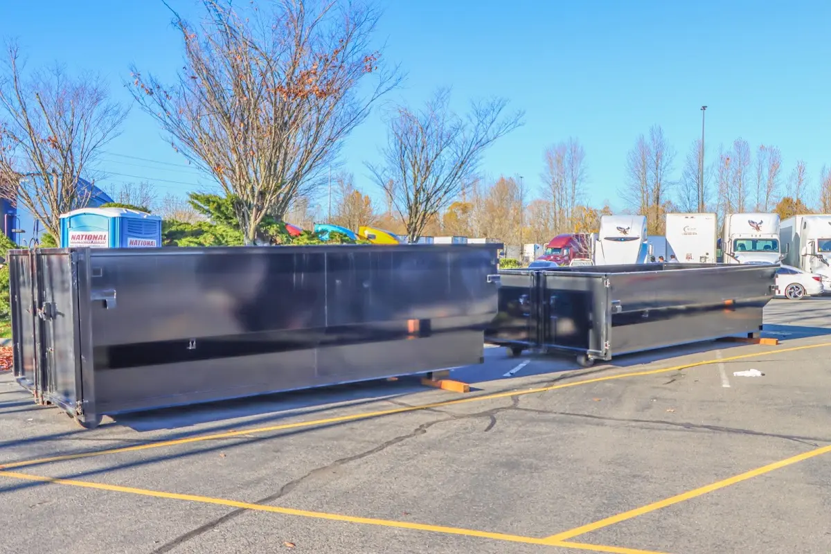 Professional dumpster rental service with roll-off container on residential driveway in Bourbonnais